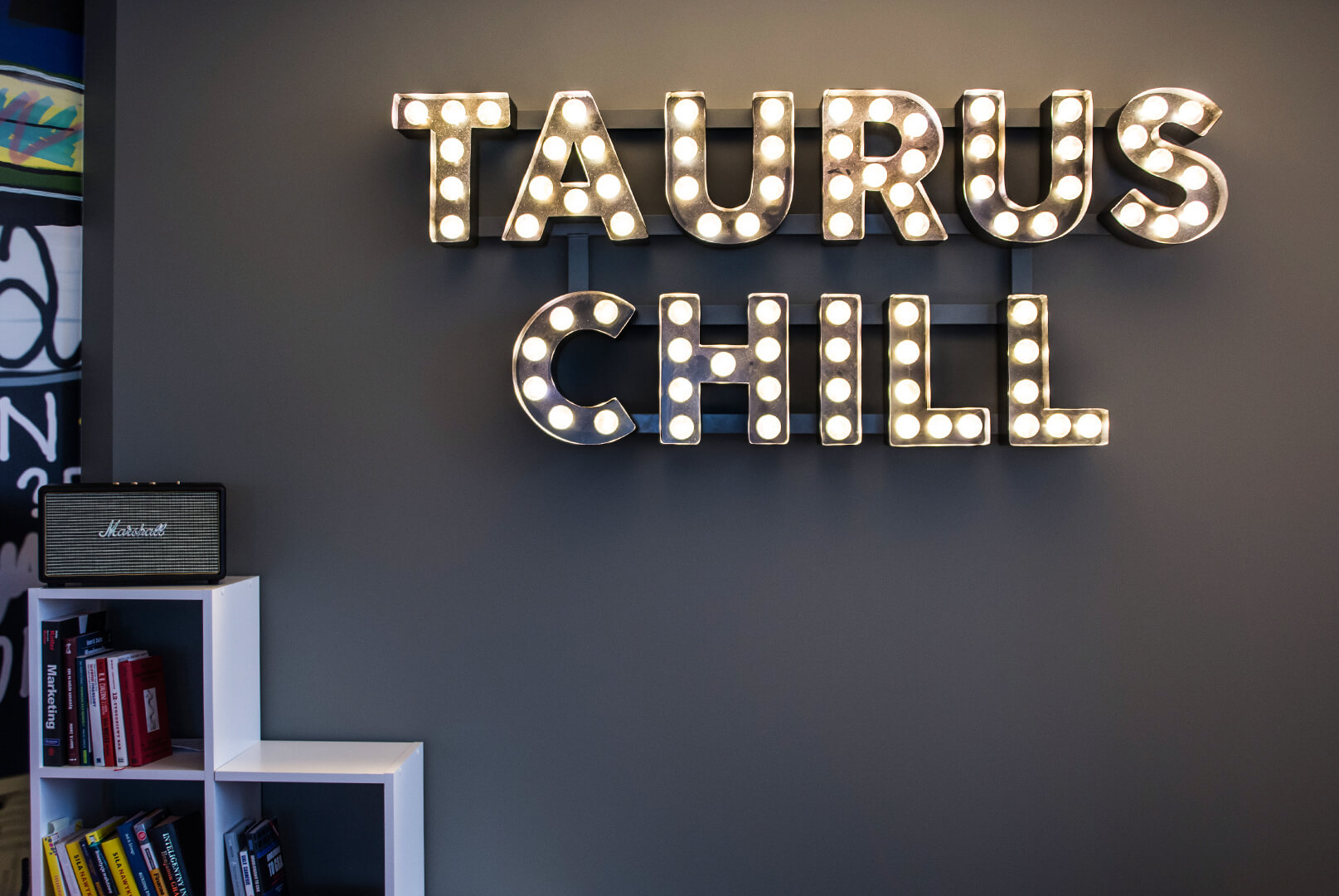 Taurus Chill - letters with light bulbs placed on the wall